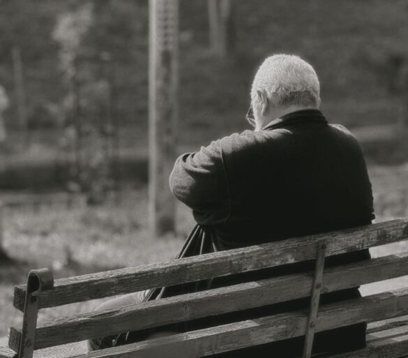 elderly man reflecting on park bench in damascus