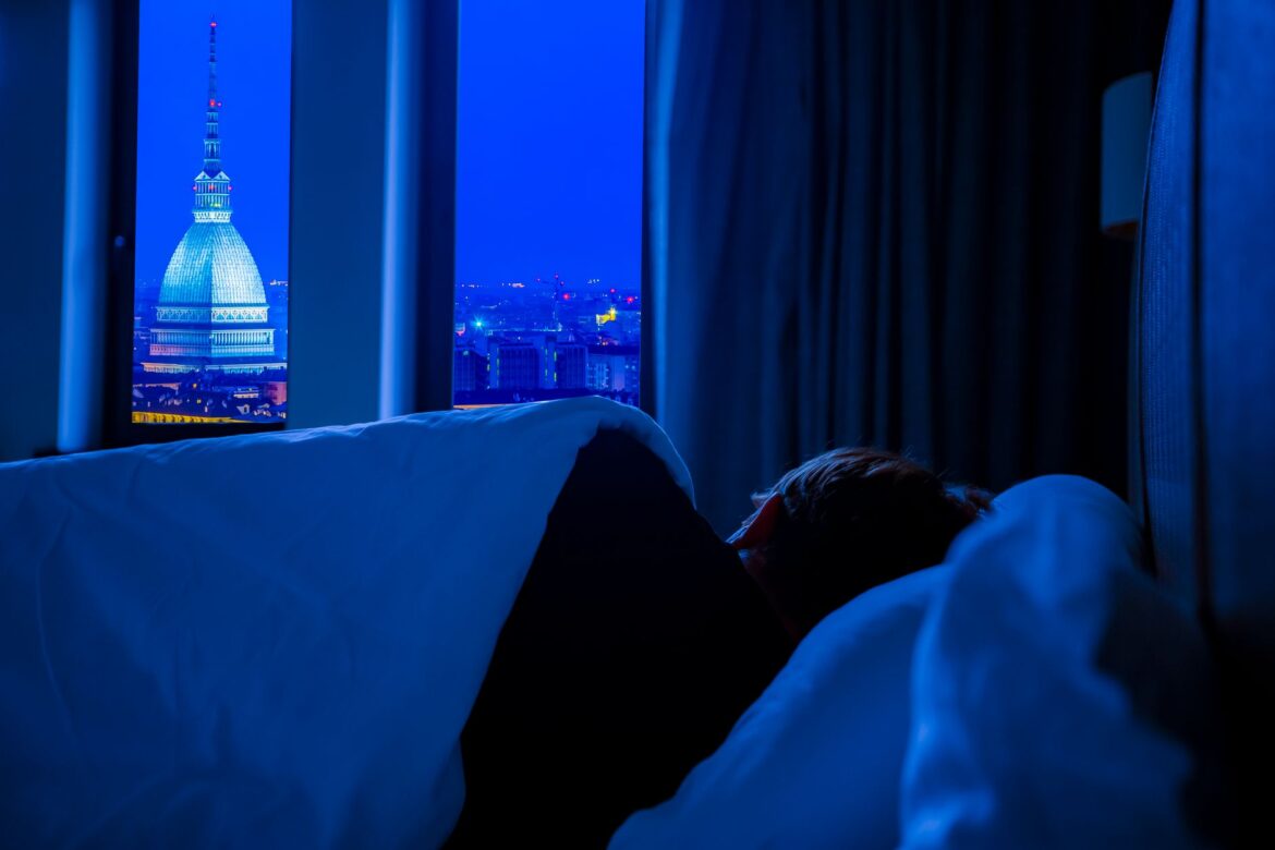 bedroom facing a city during night time